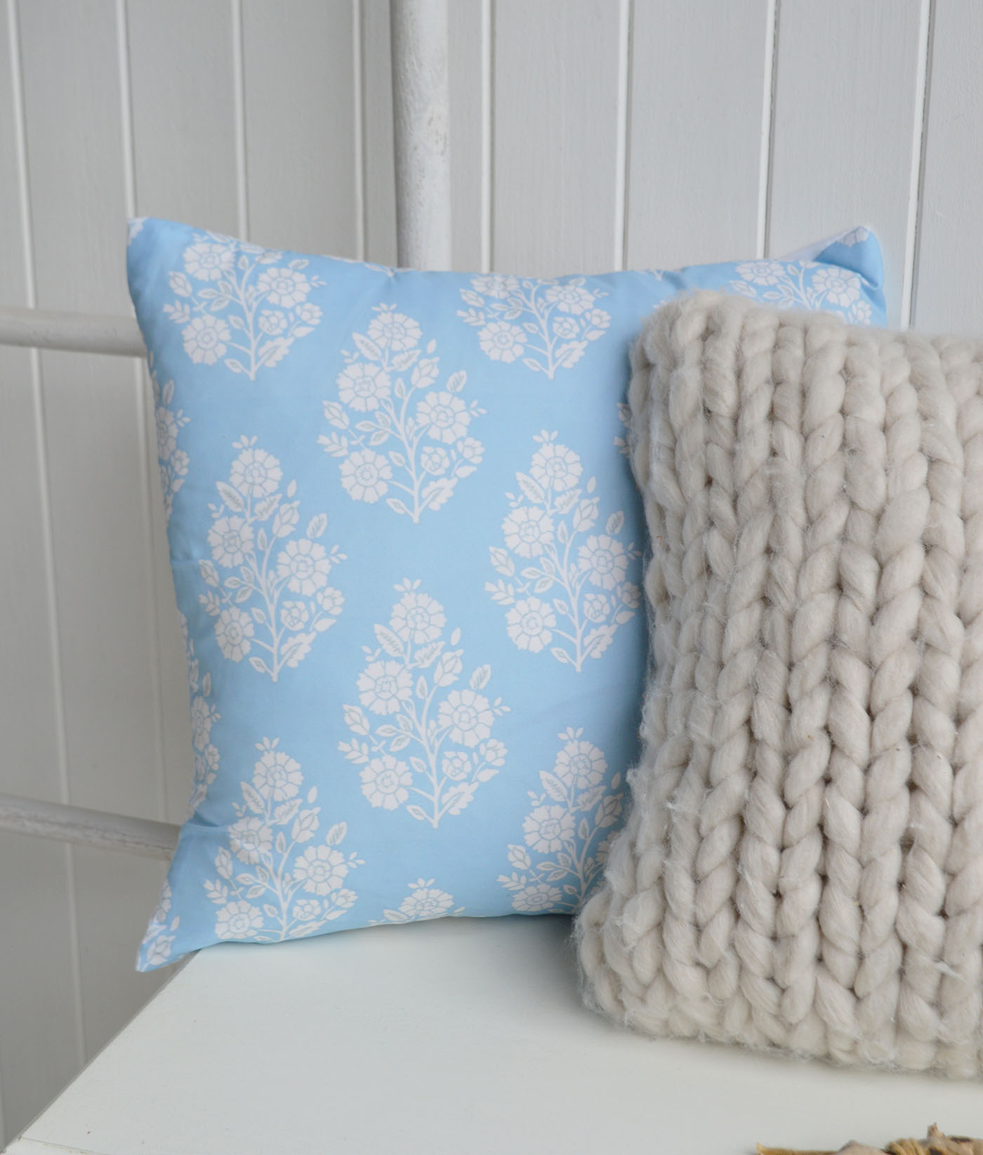 Soft sky blue tones and delicate floral detailing bring a fresh New England feel, beautifully paired with cosy neutral textures.