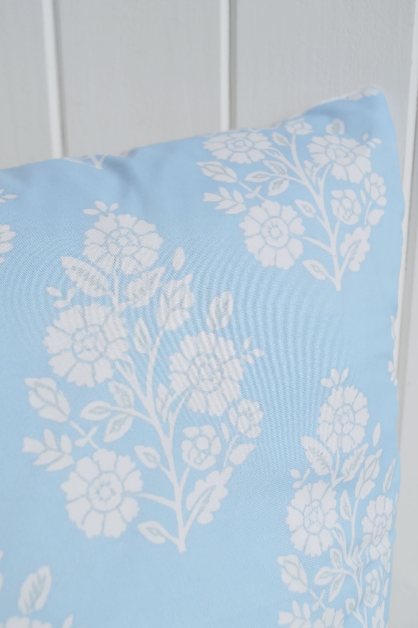 A delicate floral print in soft powder blue brings a light and elegant coastal feel to relaxed interiors.