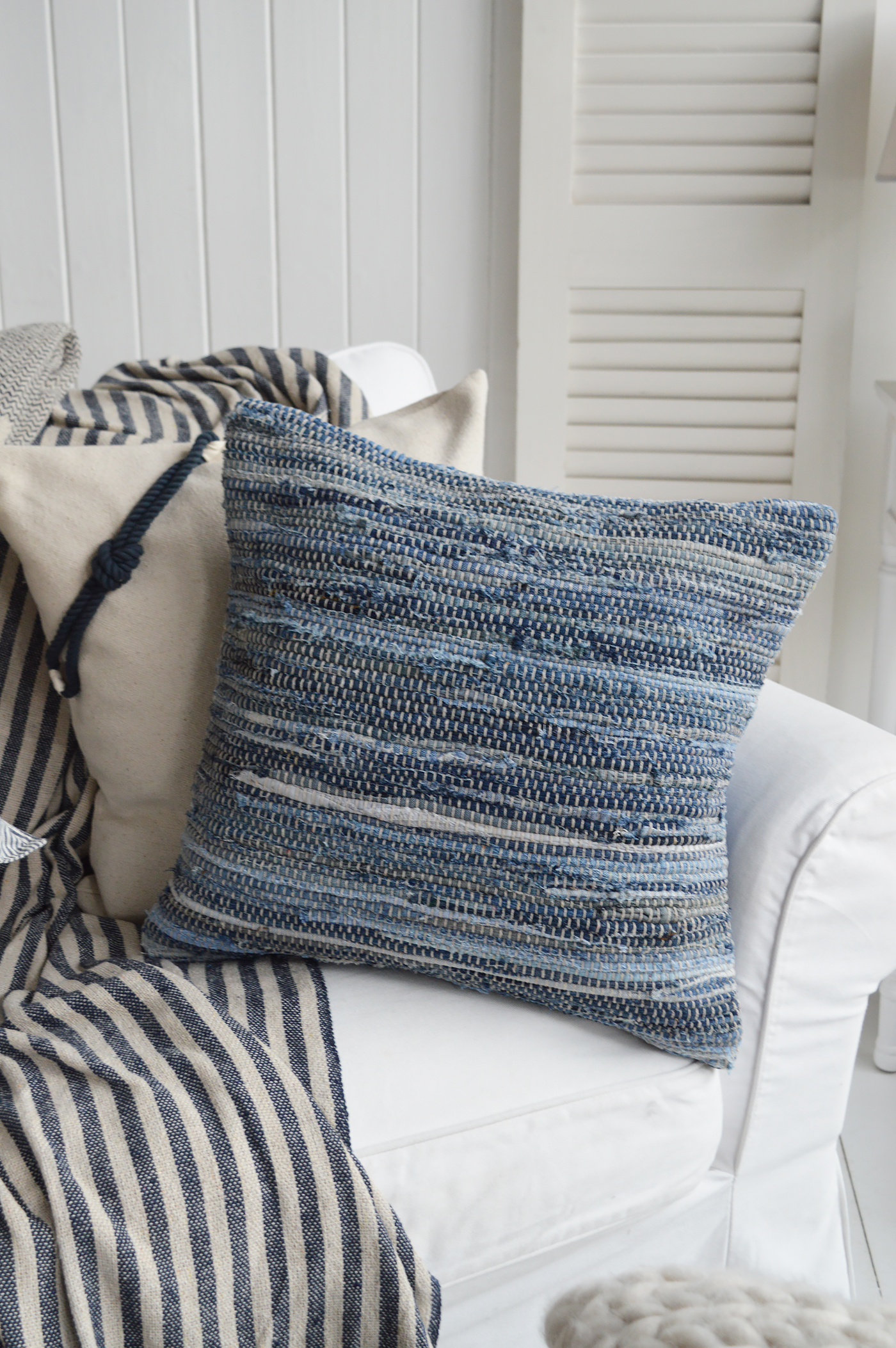 Striped blue cushion designed for comfort and style in coastal beach interiors.