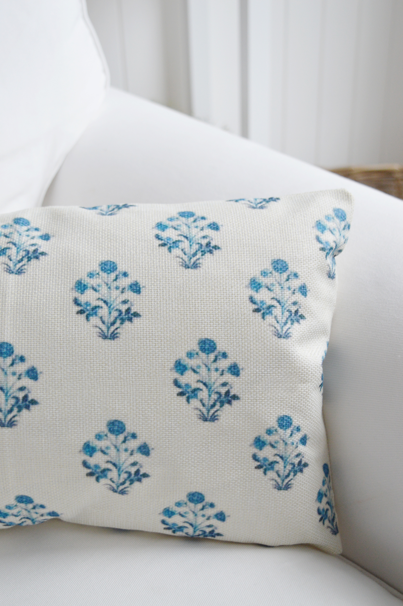 Layer this coastal cushion cover with navy stripes and textured throws for a relaxed Hamptons look.