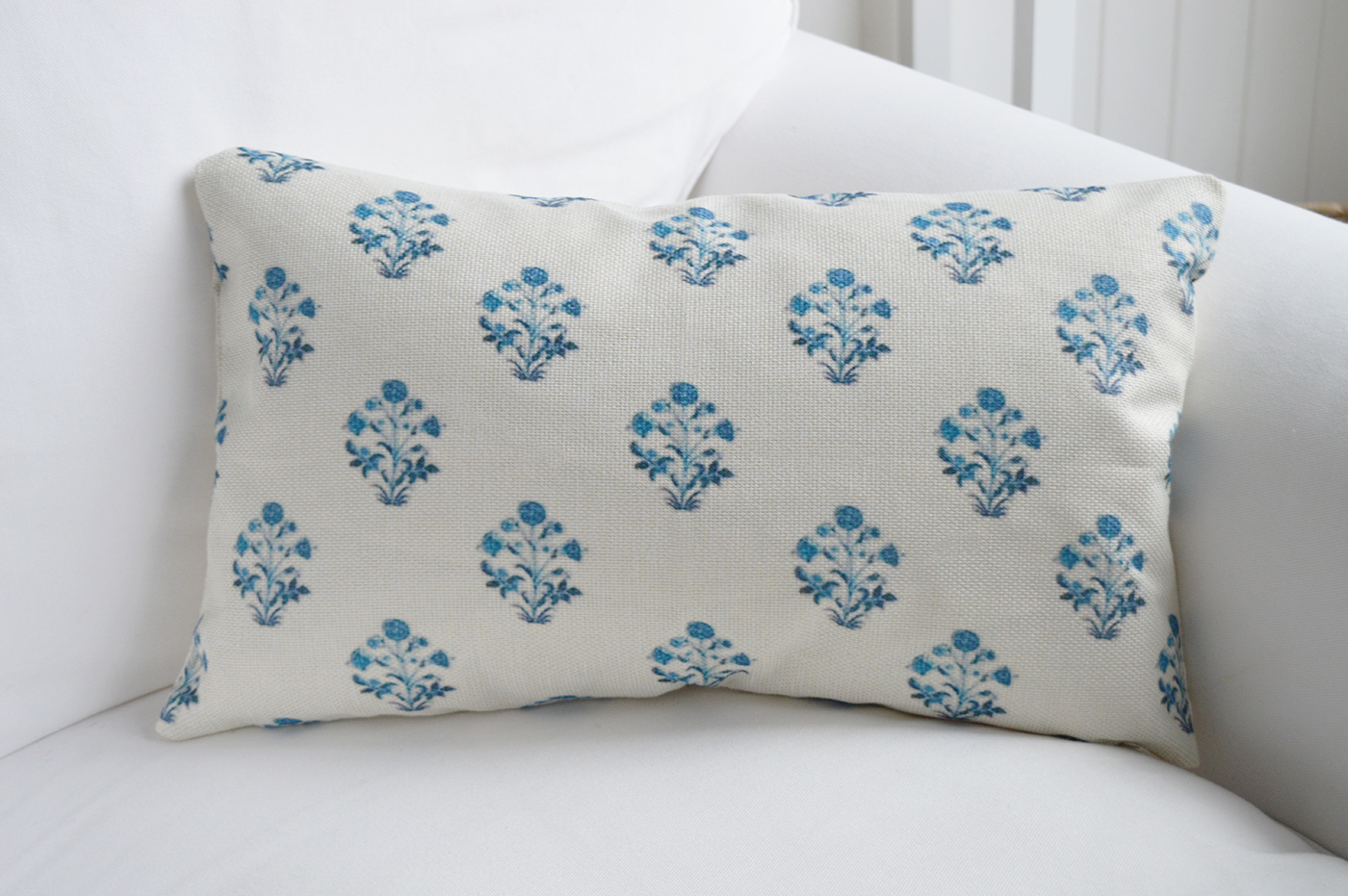 A timeless choice for neutral interiors, this ivory and blue cushion pairs effortlessly with linen sofas and driftwood furniture.