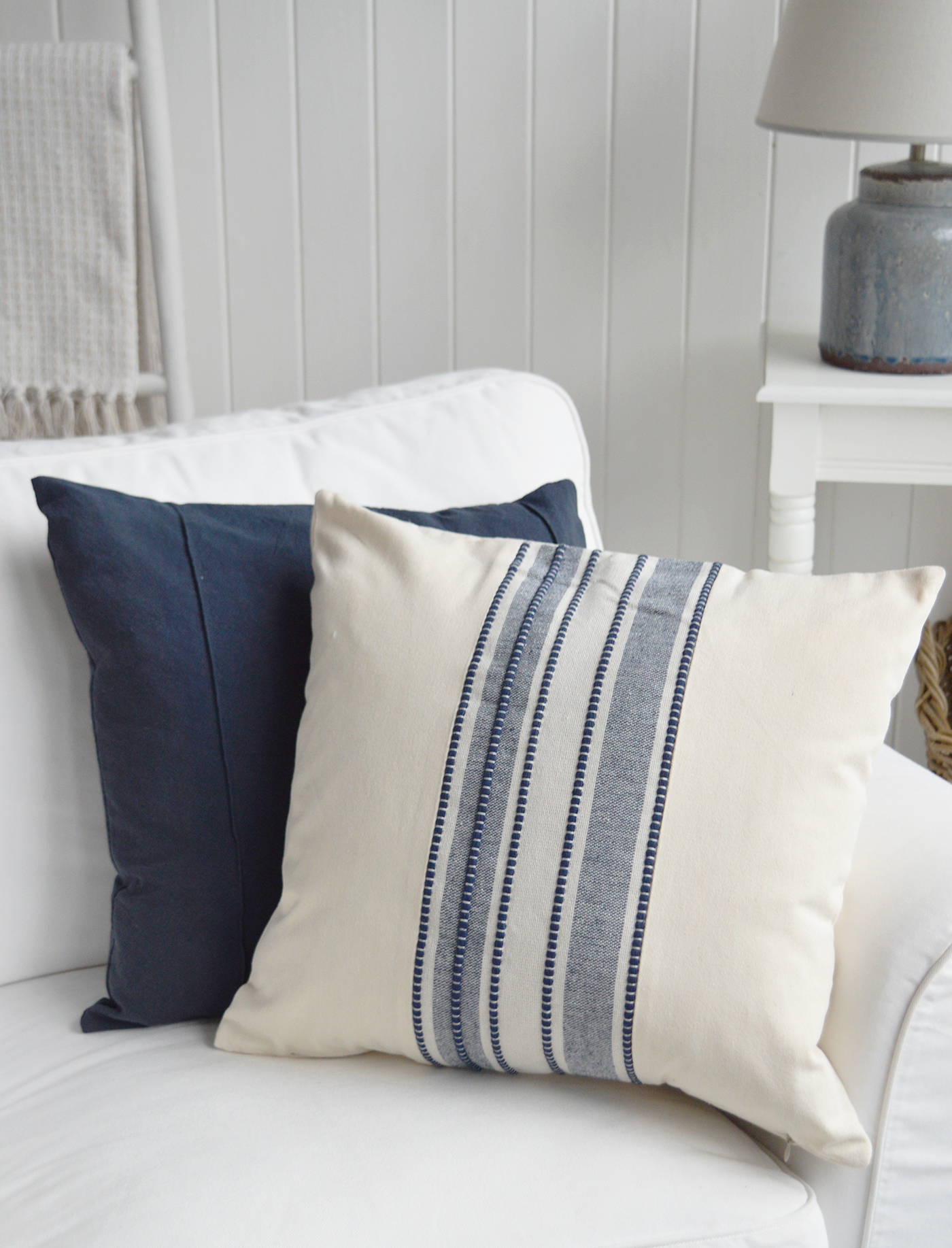 A woven navy stripe adds texture and character to this warm ivory coastal cushion cover.