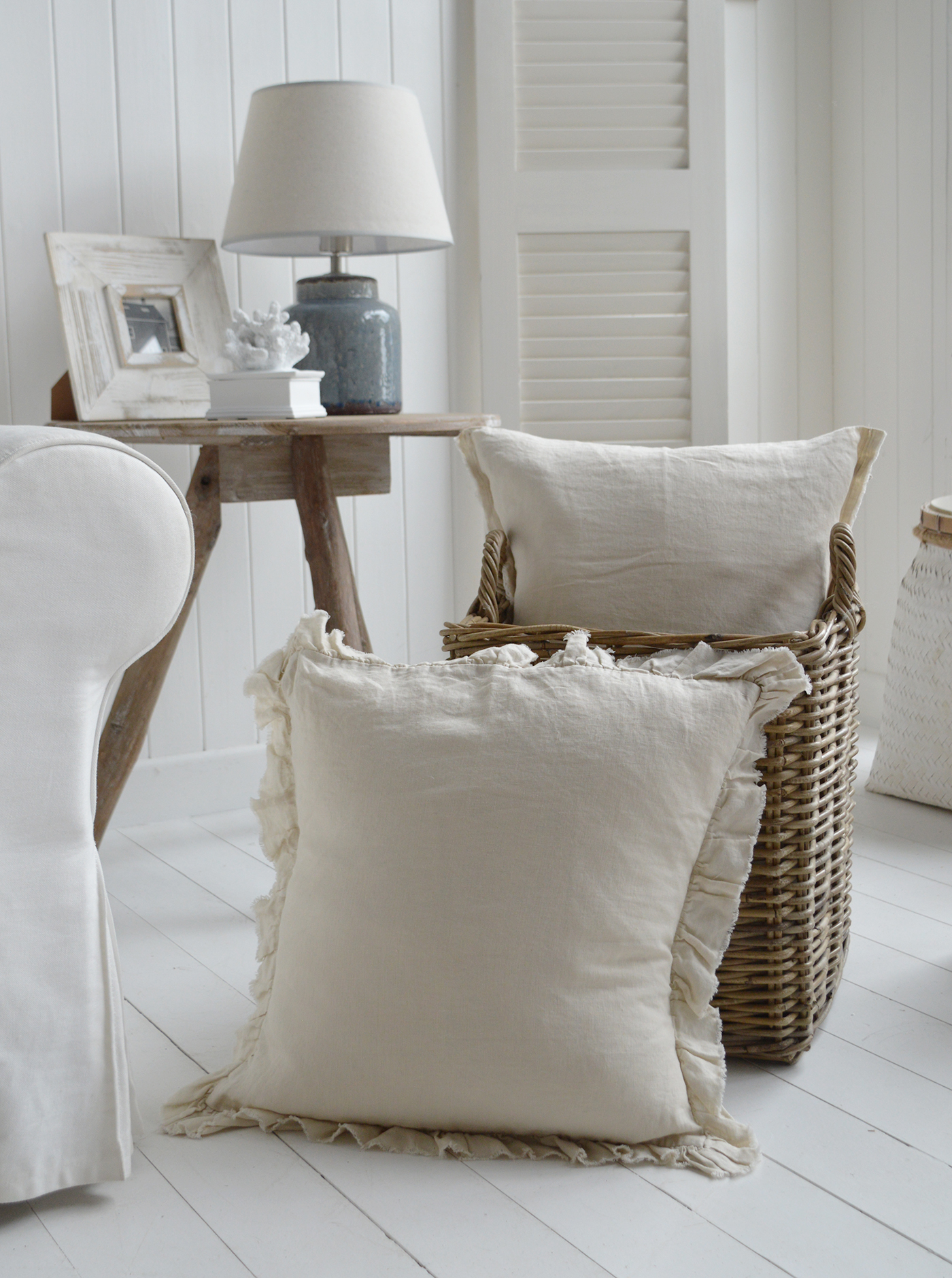 The Hamilton cream 100% linen cushion covers complementing the greyed Casco Bay basket in a beach house home
