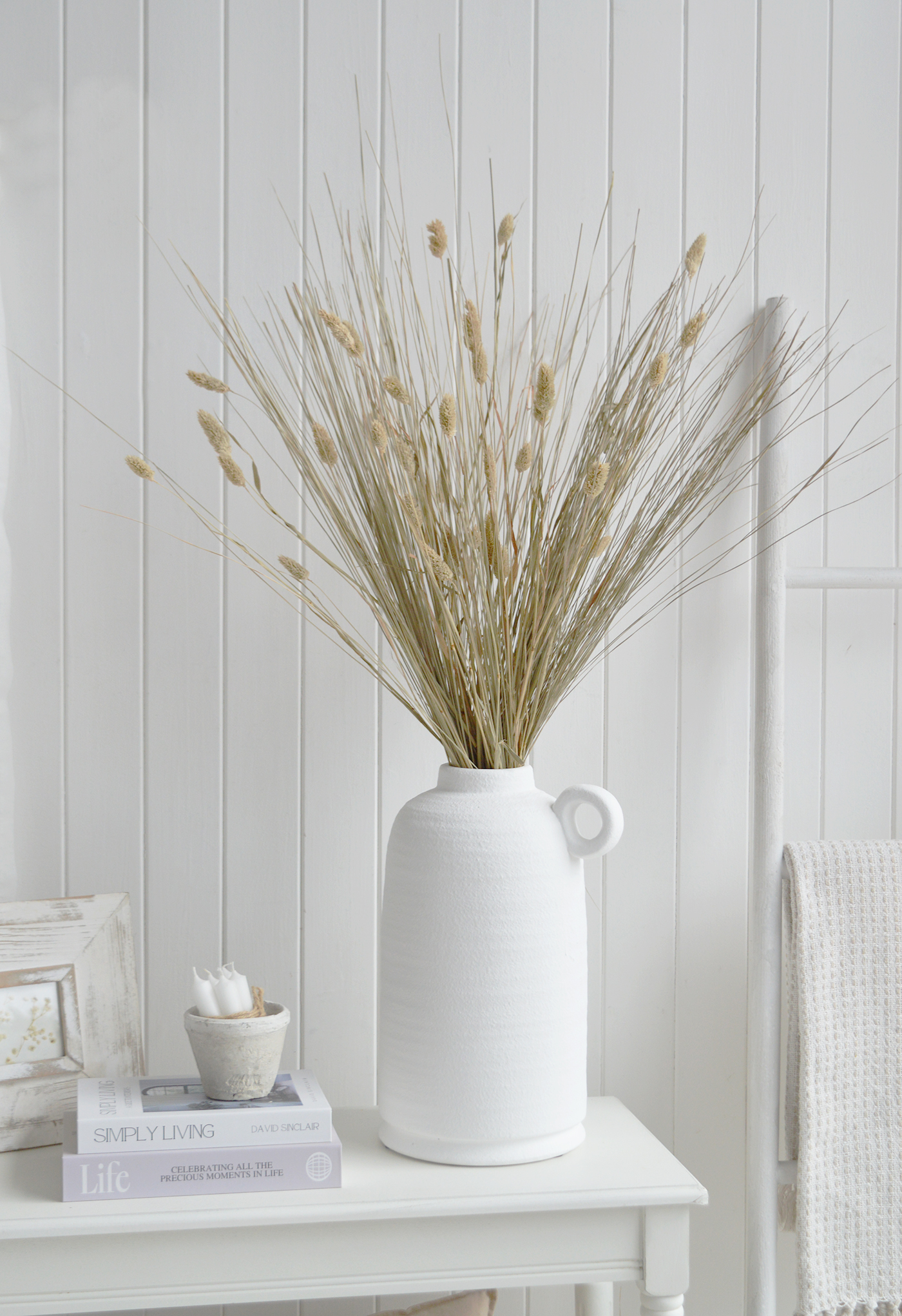Pair this dried grass bunch with ceramic vases, woven baskets and natural wood furniture for a relaxed, layered coastal look.