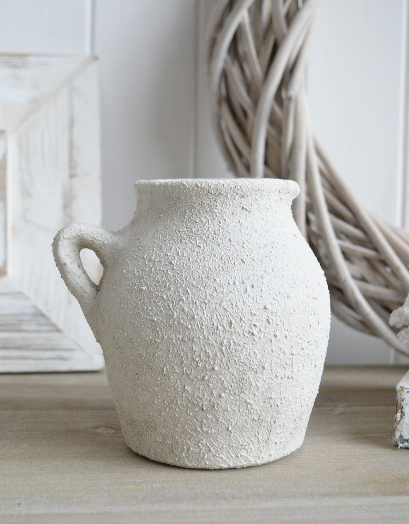 The Fremont aged white stone vases feature a weathered, textured finish that exudes rustic charm for all coastal and farmhouse settings
