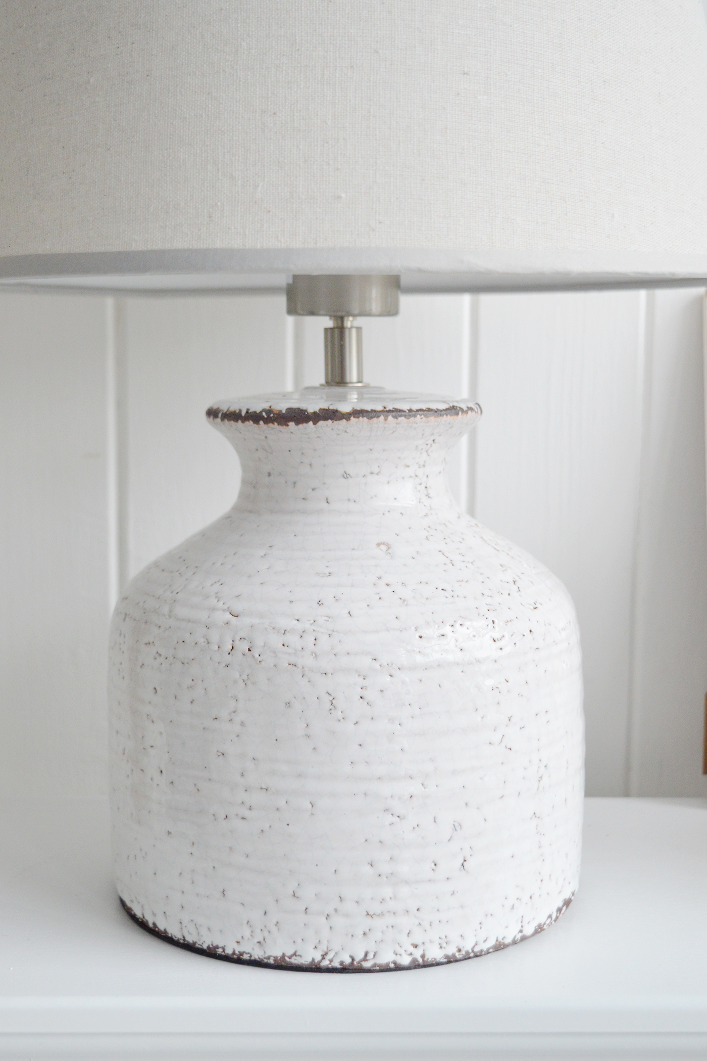 The White Compton white ceramic lamp with a glazed finish for a beautiful white coastal beach house interior