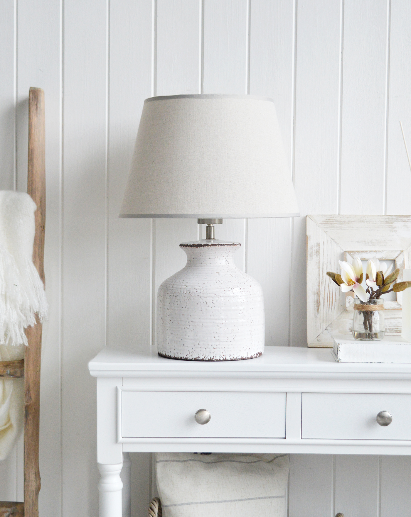 The White Compton white ceramic lamp with a glazed finish in a white living room 