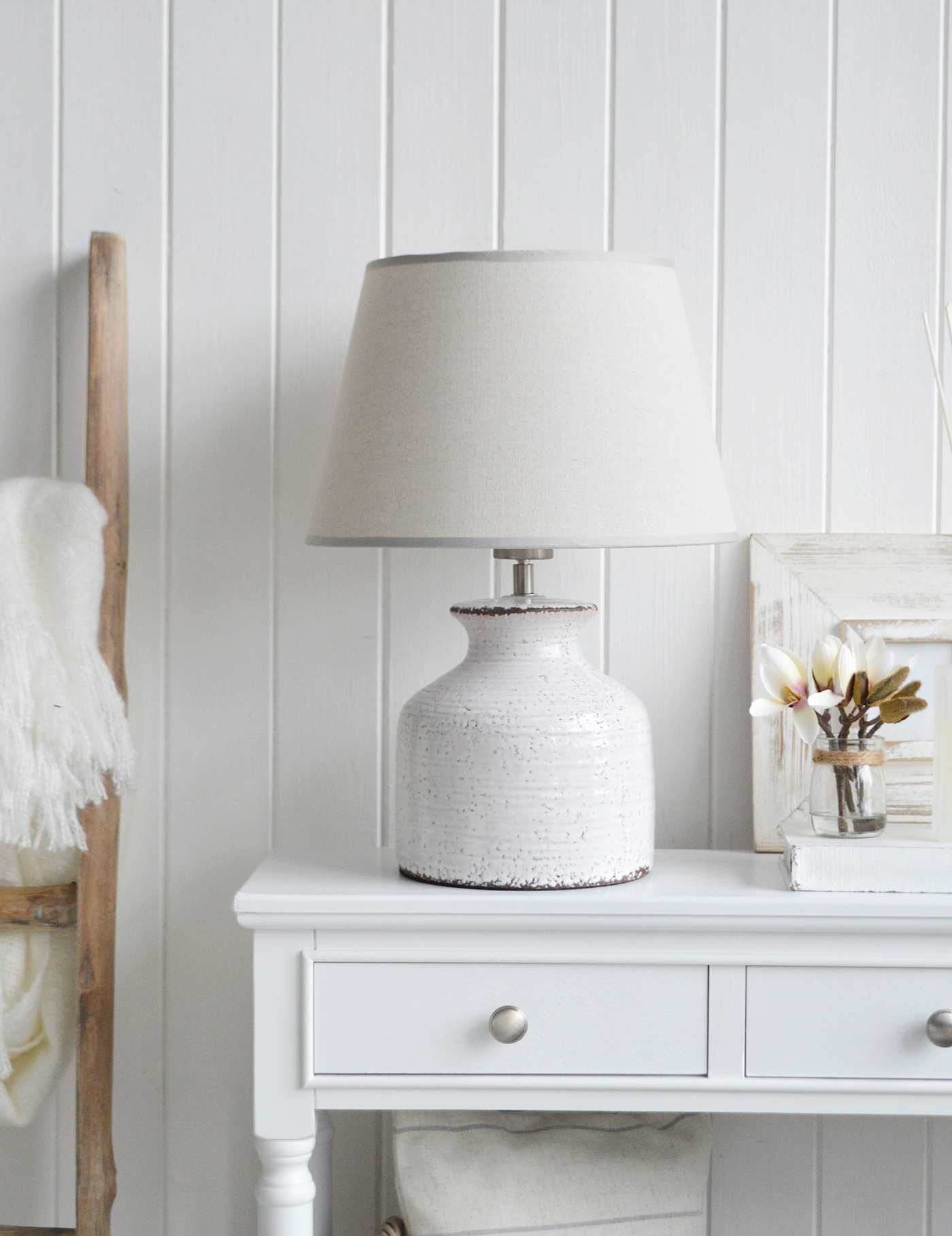 The White Compton white ceramic lamp with a glazed finish  in a white coastal inspired living room