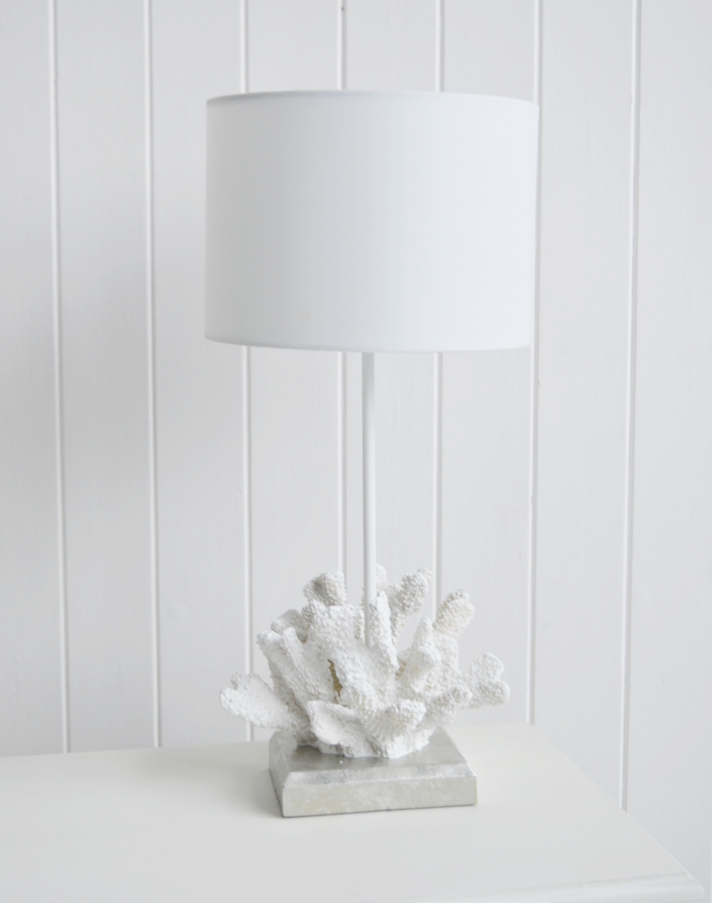 The textured coral base adds depth and interest to neutral living rooms and coastal bedroom styling.