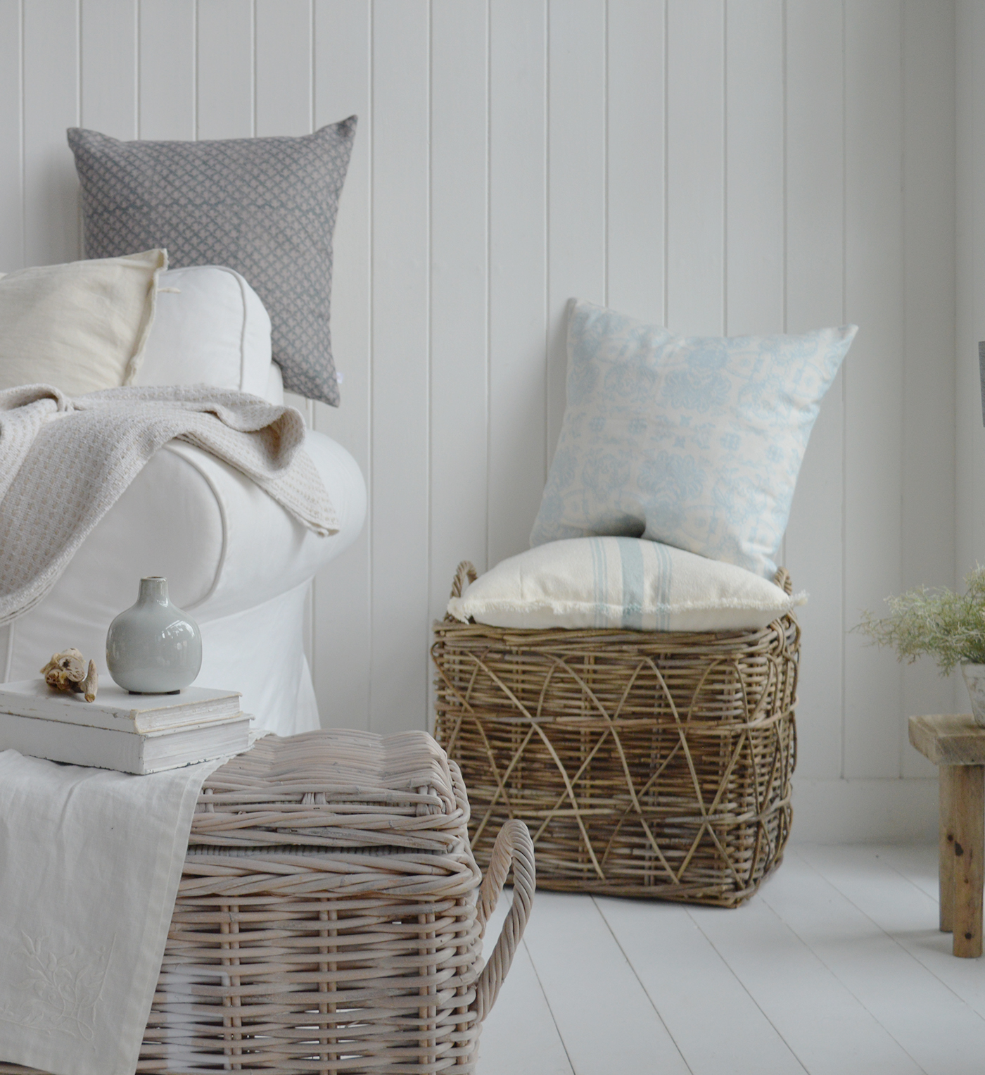 Layered coastal cushions creating a relaxed beach look