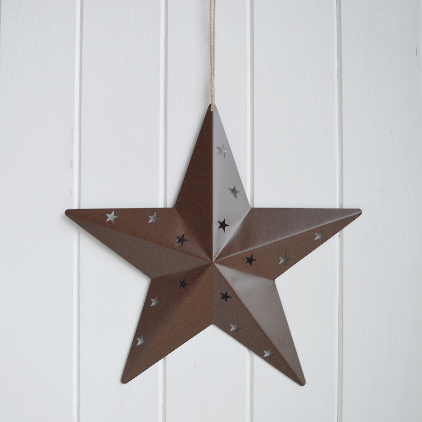 Crafted from metal with subtle star cut-out detailing, they create depth without overpowering a neutral space.