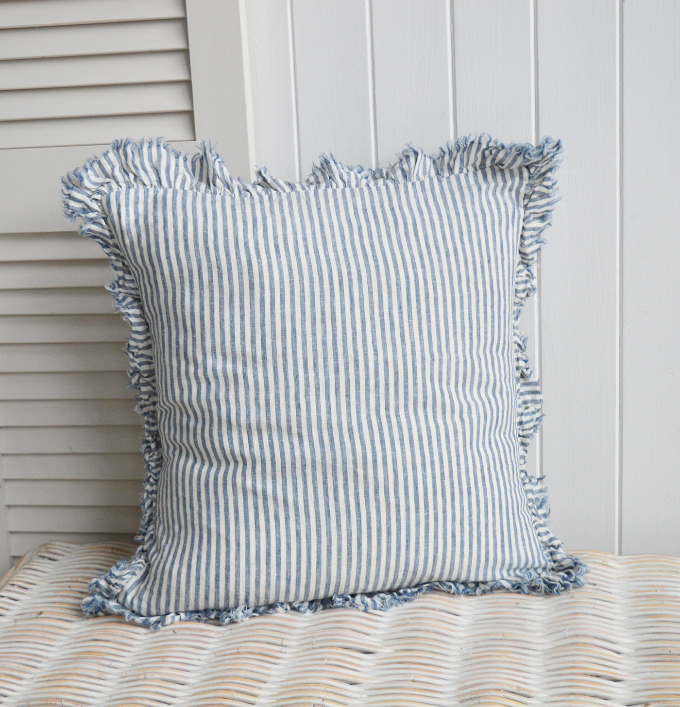 Navy and white pin stripe cushion cover in linen with a ruffled edge