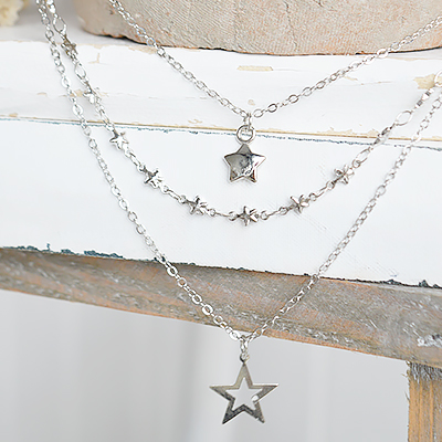 A delicate layered star necklace inspired by relaxed New England coastal style.
