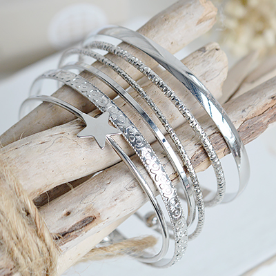 This set of six silver-tone bangles is inspired by the relaxed elegance of the New England coastal lifestyle.
