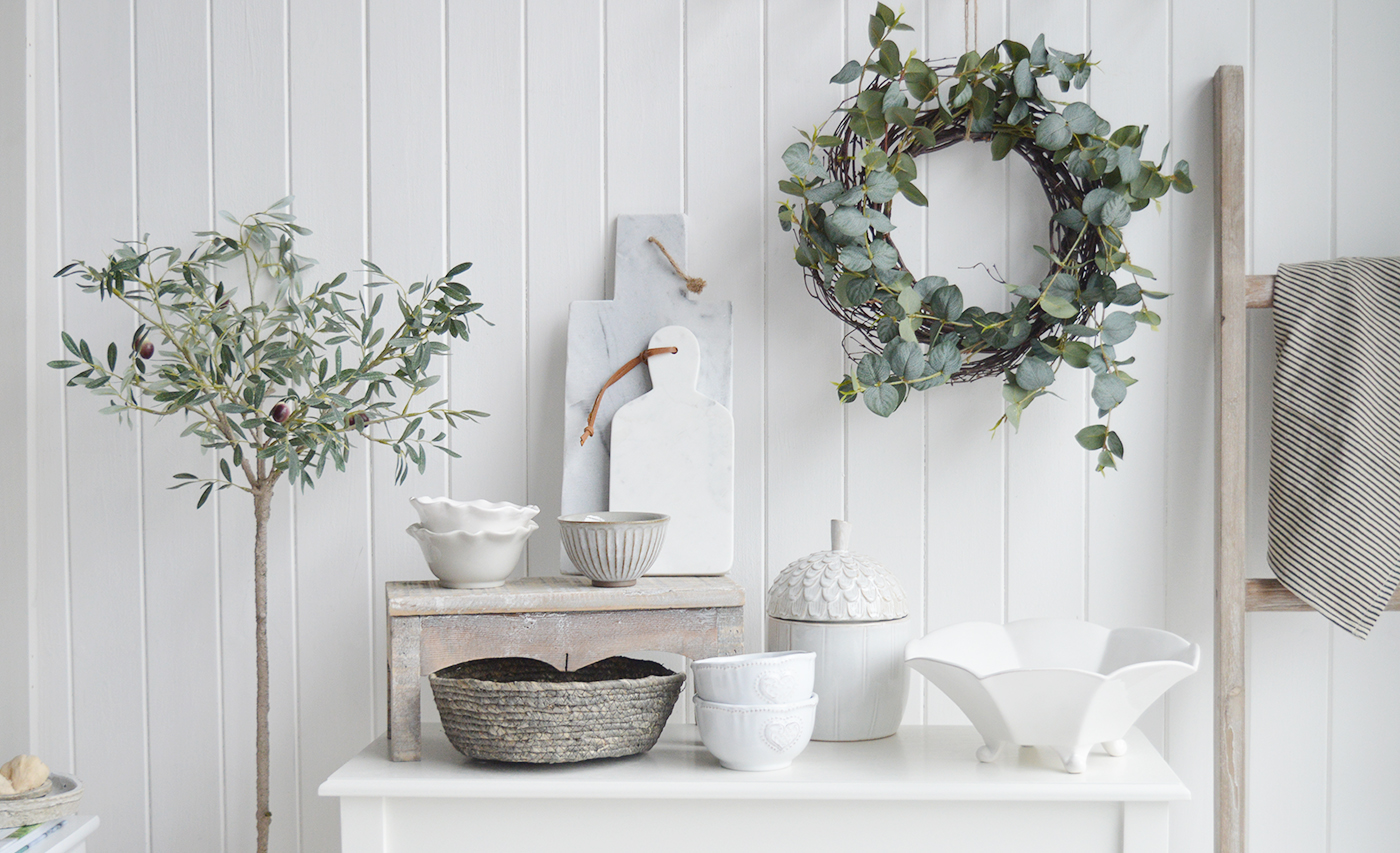 New England white interiors and furniture for country, coastal and modern farmhouse homes. White ceramics contrasting against the dusky leaves from The articial olive tree