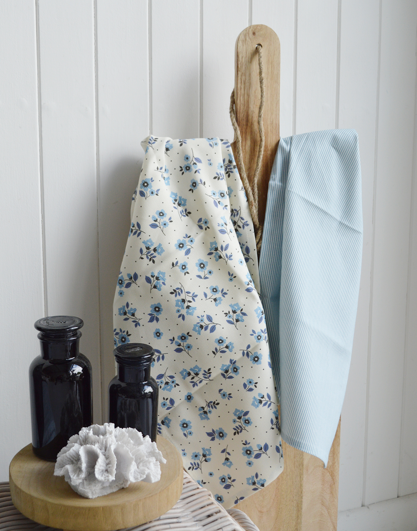 Elegant blue floral tea towel from the Piermont range hanging on a hook