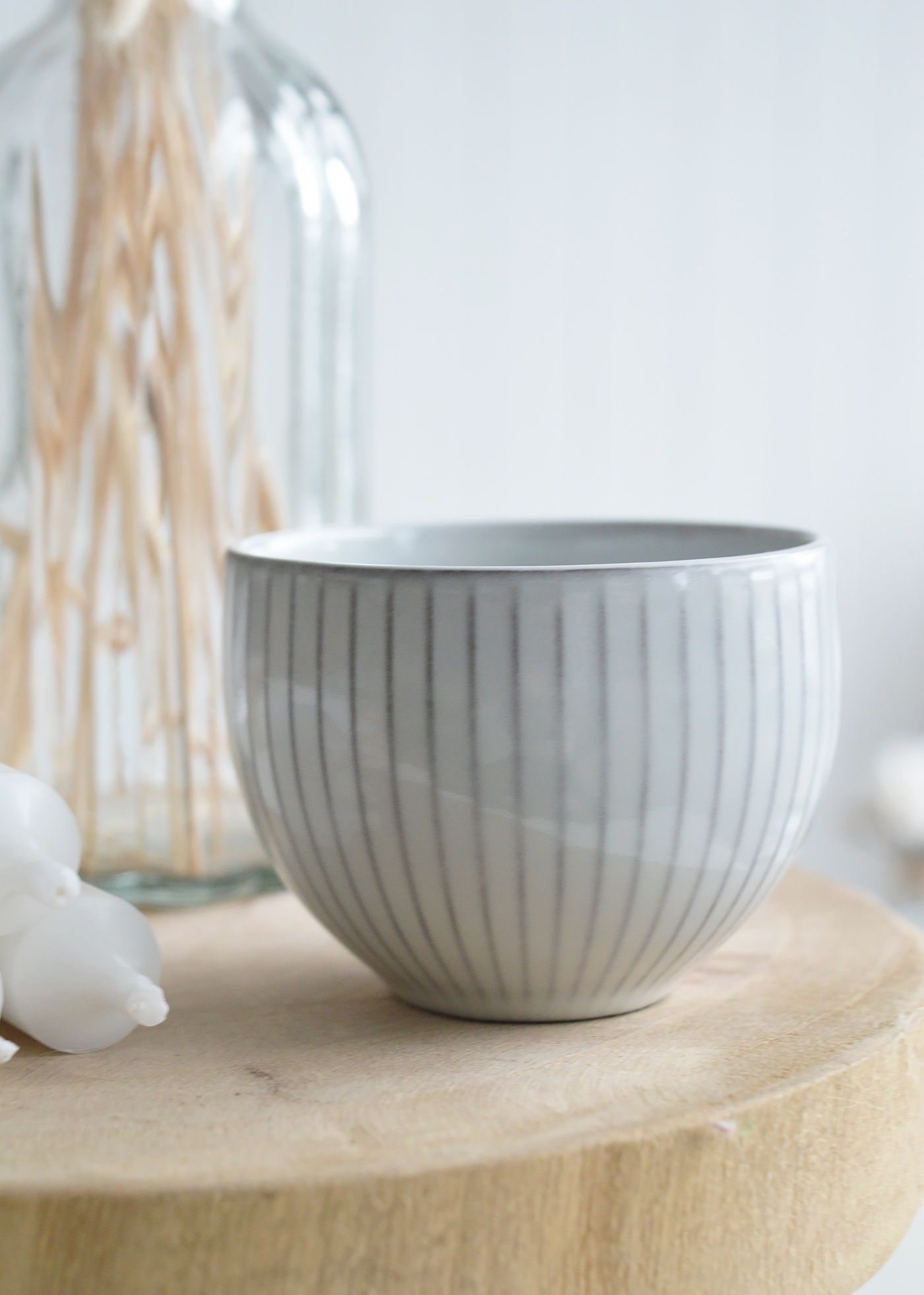 The small grey ceramic bowl, with its soft matte finish, adds a subtle elegance to a New England coastal kitchen, perfect for holding sea salt or fresh herbs.