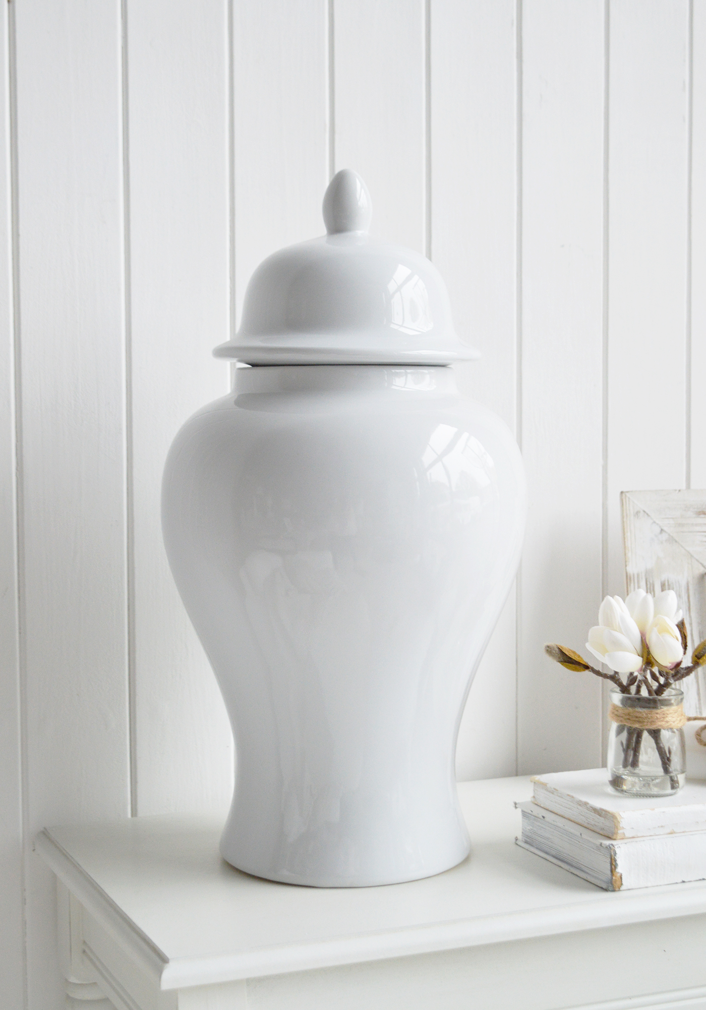 The tall white Porter Jar brings graceful height and timeless simplicity to coastal and country interiors.