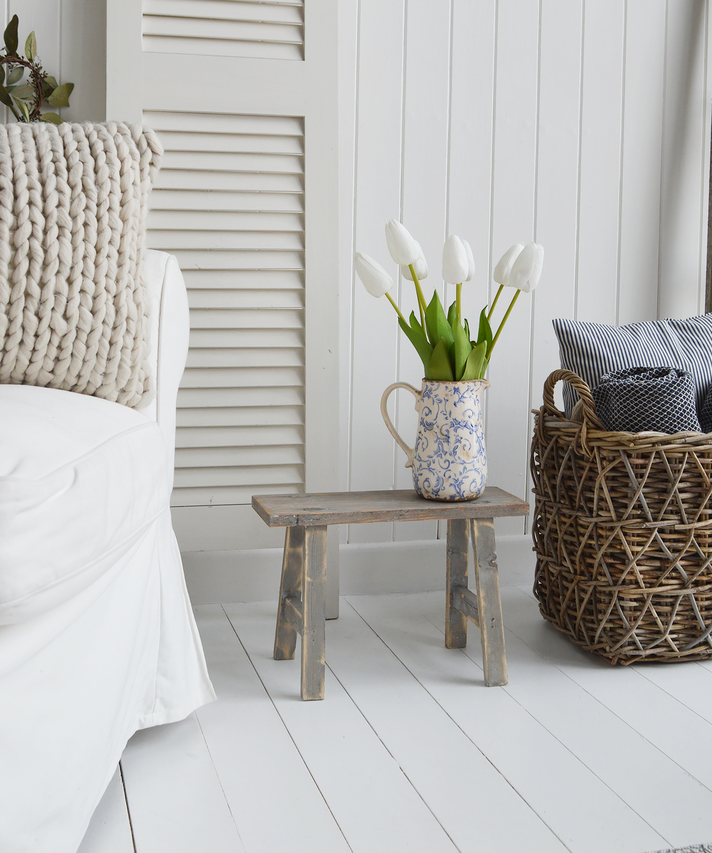 The Prospect blue and white vintage pitcher with white faux tulips on the grey Pawtucket stool