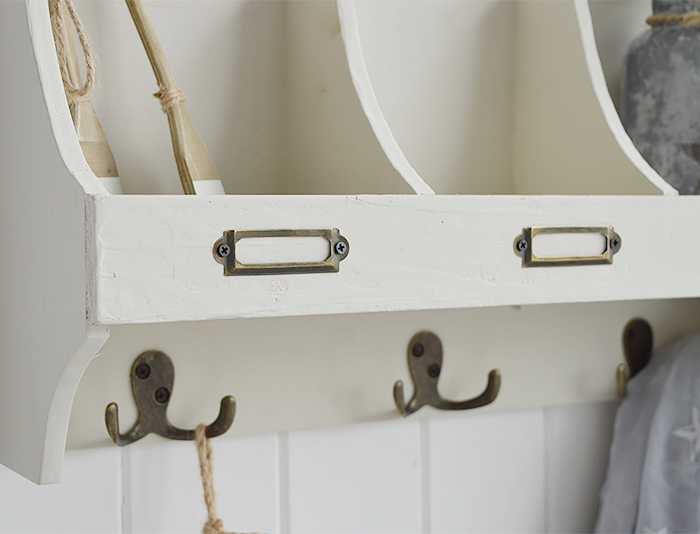 white wooden wall shelf with hooks in beach house aged finish, ideal for hallway as coat storage or in bathroom and bedroom. Photograph to show the finish