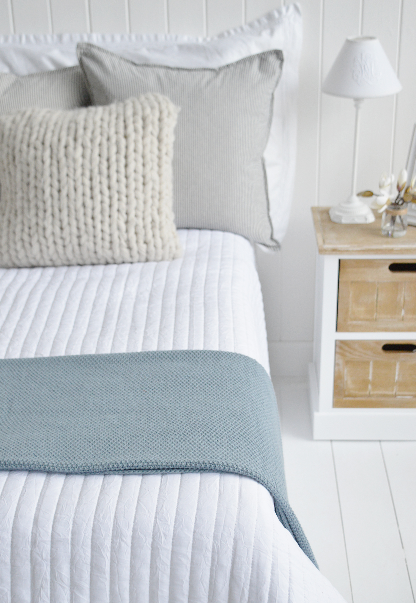 The Harrington dusky blue textural throw on a bed for modern coastal and country interiors