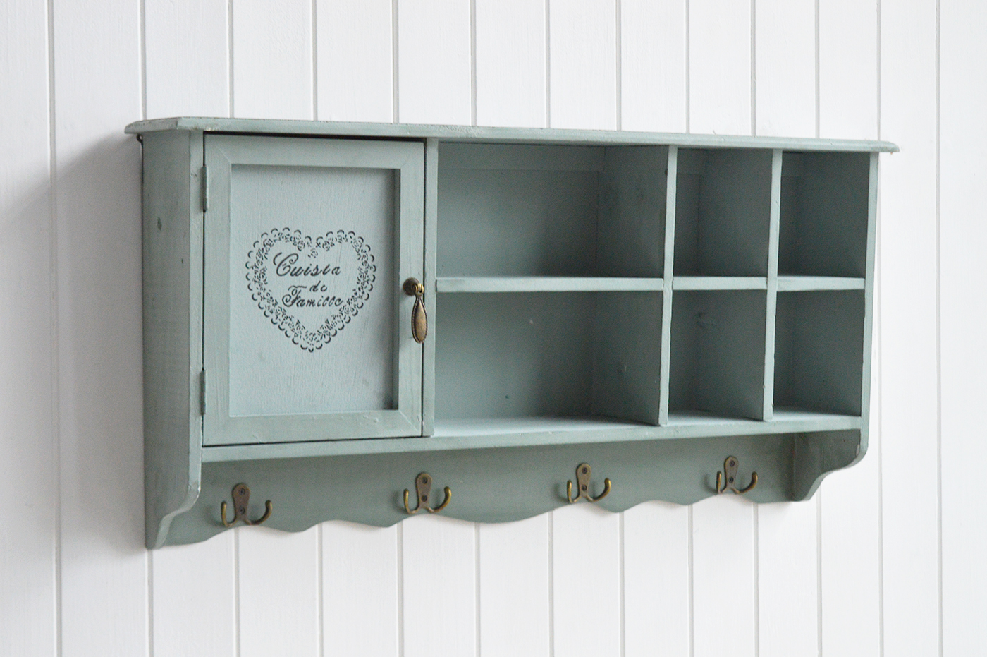Decorative farmhouse furniture and interiors piece with antique brass hardware, cubby shelves, and a sage green country finish.