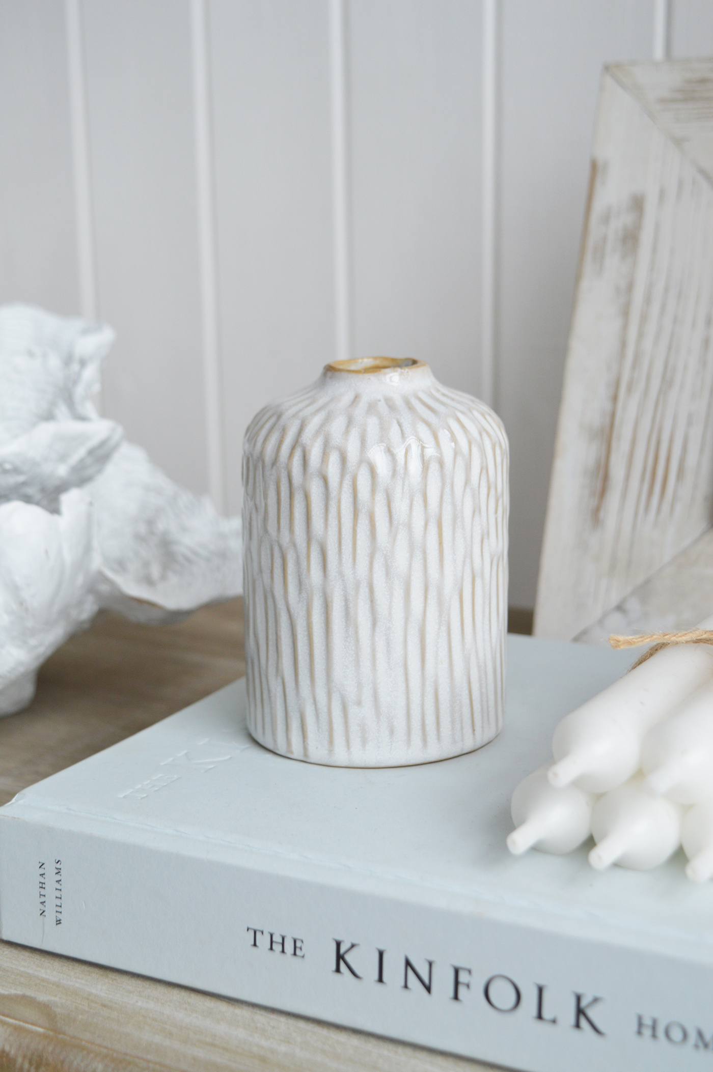 With its soft rippling texture and crisp white finish, the Charlotte ceramic bud vase brings a touch of coastal serenity to any space