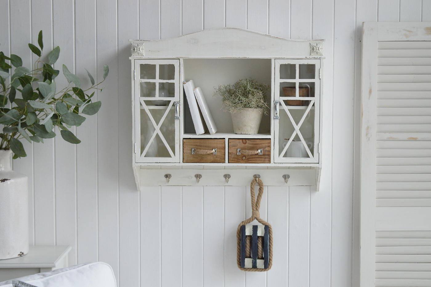 Distressed wooden pulley accent for seaside cottages and coastal interiors.