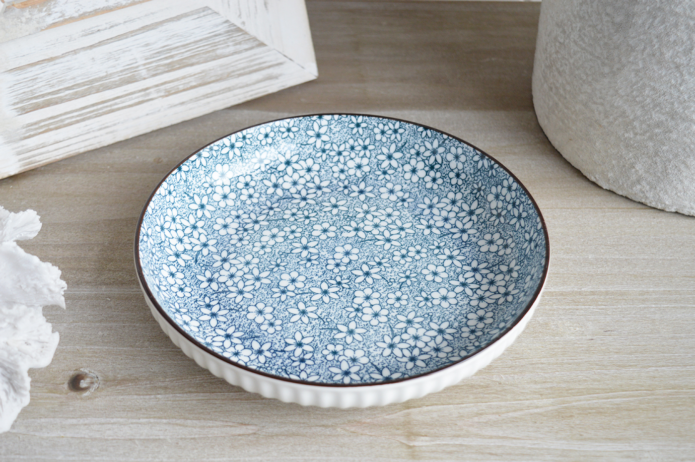 The delicate floral motifs are balanced by clean, sculpted lines that bring a refined texture to every table setting.