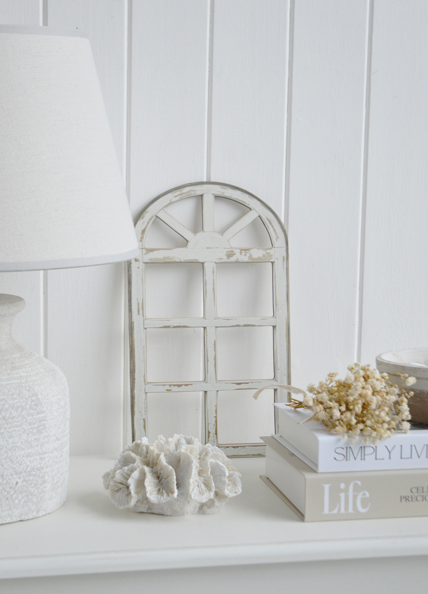 The distressed finish adds character and architectural detail to neutral console table styling.