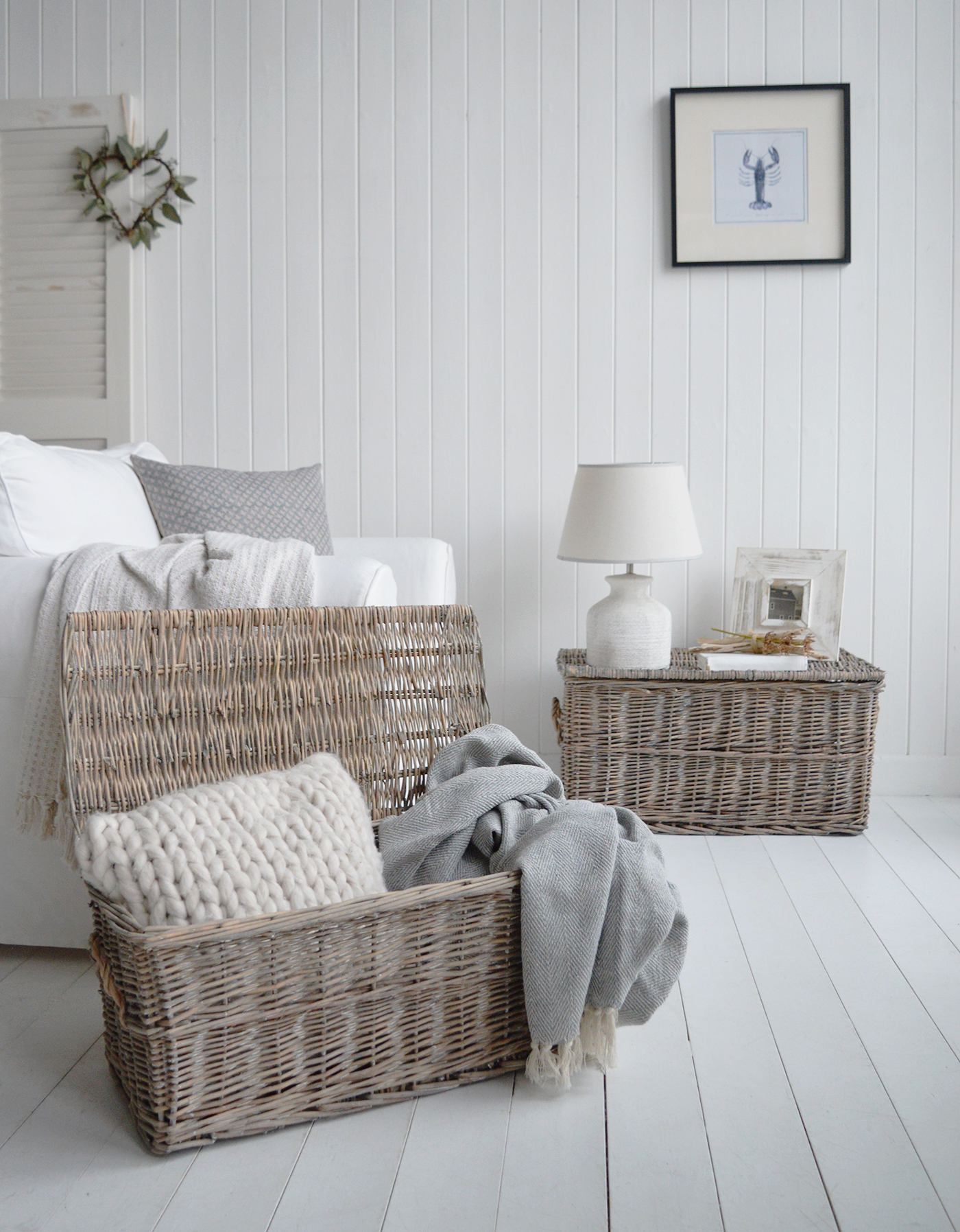 A single trunk used as a side table adds gentle coastal texture beside a sofa—beautiful, useful and calm in beach house neutrals