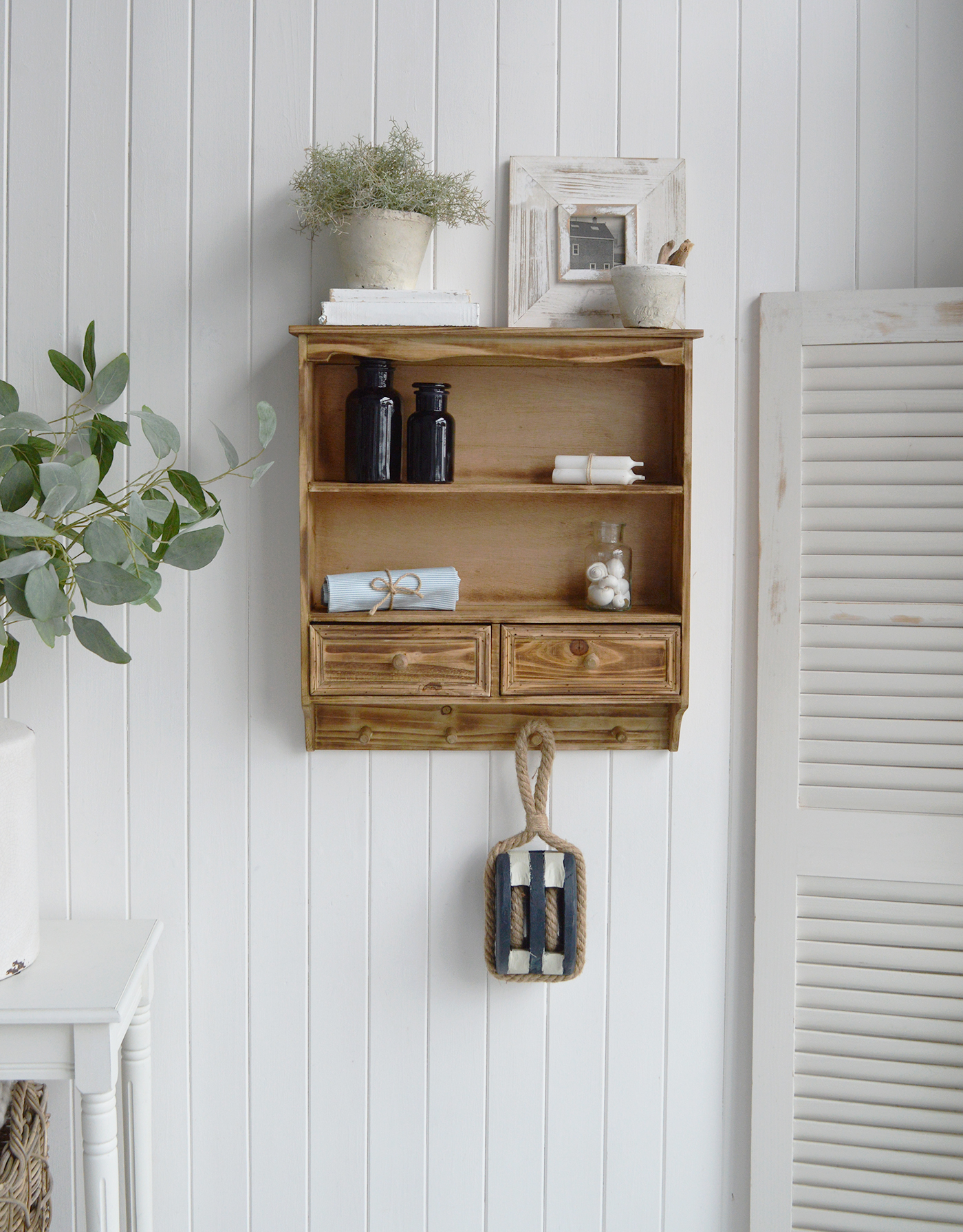 Solid wood wall shelf in a natural finish, adding farmhouse storage and charm to rustic interiors