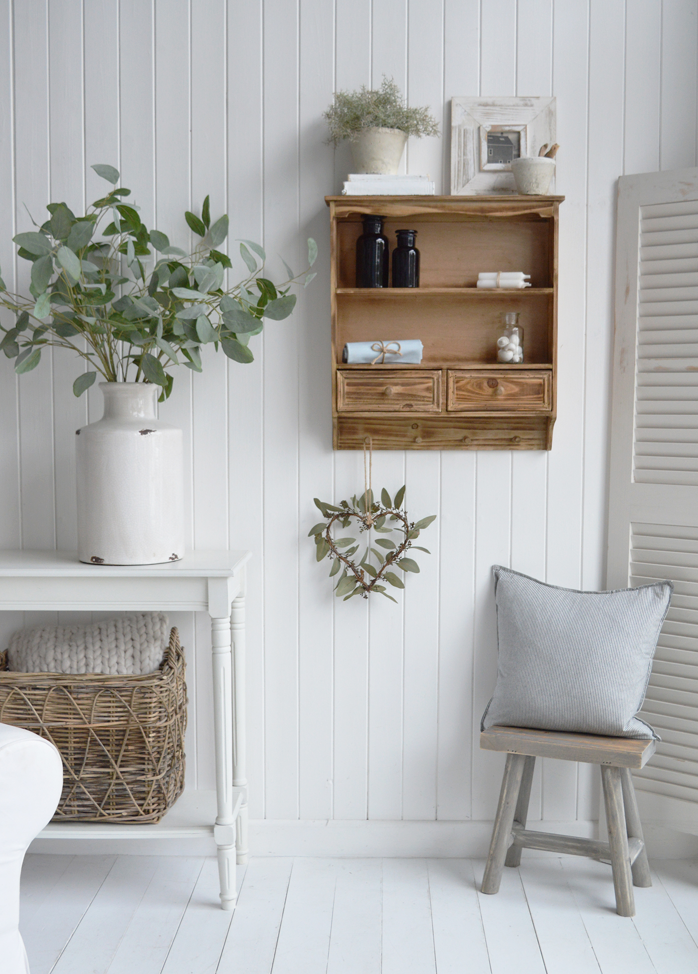 Farmhouse wall shelf with open shelving and wooden pegs, ideal for cozy country home décor.