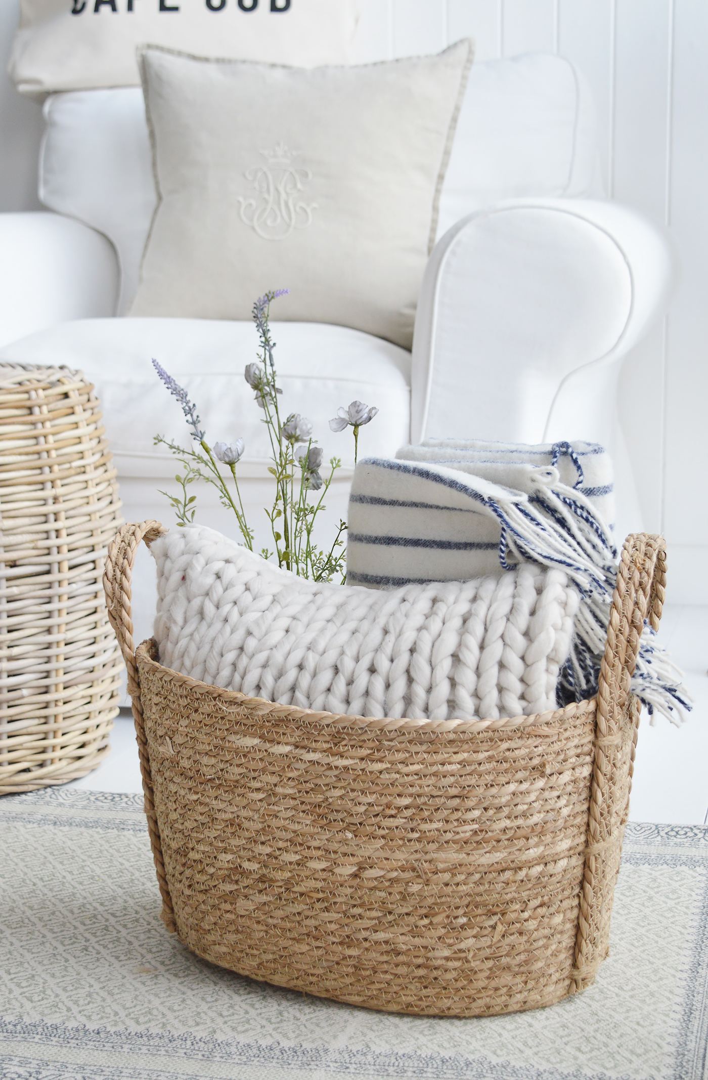 The artificial blue rose spray with cushions and Sudbury throw in the fall River basket for a relaxed New England feel