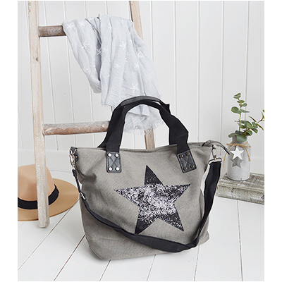 A gorgeous charcoal bag with a detachable shoulder strap and two carry handles with a large sparkly star.

The thick canvas and beautiful detailing aroung the handles make this a sturdy daily carry bag.