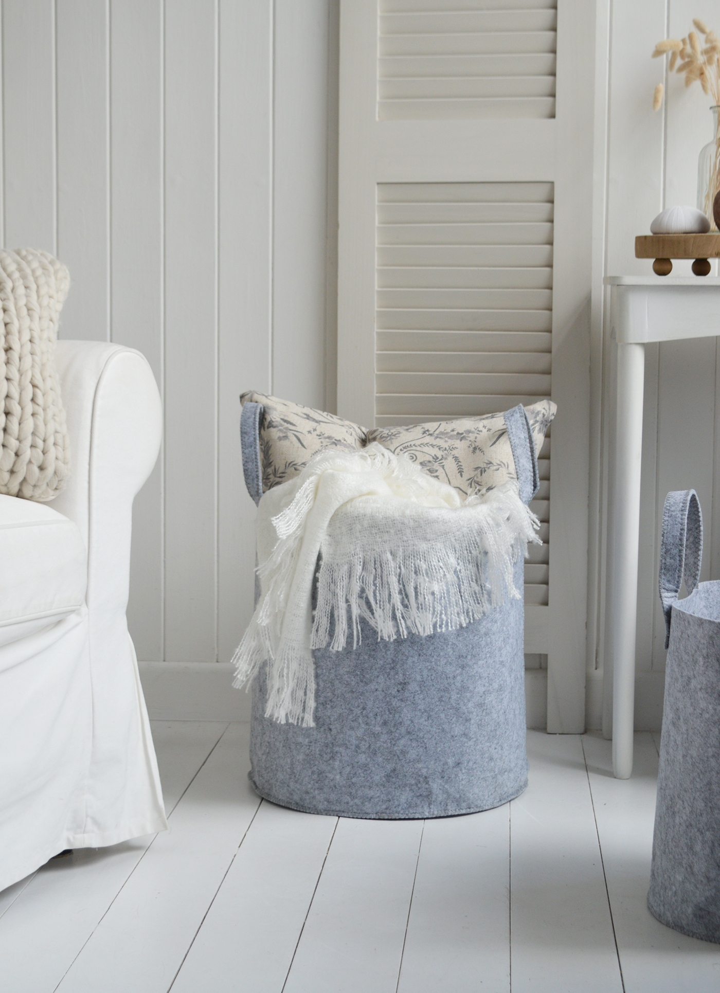 A close up of the Kittery largest basket filled woith throws and cushions, perfect for storge and to style modern farmhouse, country and coastal homes and interiors