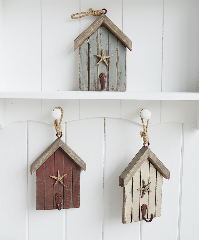 The White Lighthouse. White Furniture and accessories for the home. Three beach hut hooks in rustic weather beaten paint in coastal colours, each with a starfish and painted hook hanging on cord. Decor designed to perfectly complement our New England Coastal and Country home interiors with our bedroom, living room and hallway white furniture - blue
