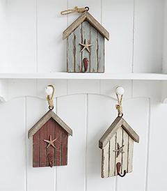 The White Lighthouse. White Furniture and accessories for the home. Three beach hut hooks in rustic weather beaten paint in coastal colours, each with a starfish and painted hook hanging on cord. Decor designed to perfectly complement our New England Coastal and Country home interiors with our bedroom, living room and hallway white furniture