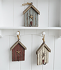 The White Lighthouse. White Furniture and accessories for the home. Three beach hut hooks in rustic weather beaten paint in coastal colours, each with a starfish and painted hook hanging on cord. Decor designed to perfectly complement our New England Coastal and Country home interiors with our bedroom, living room and hallway white furniture - blue