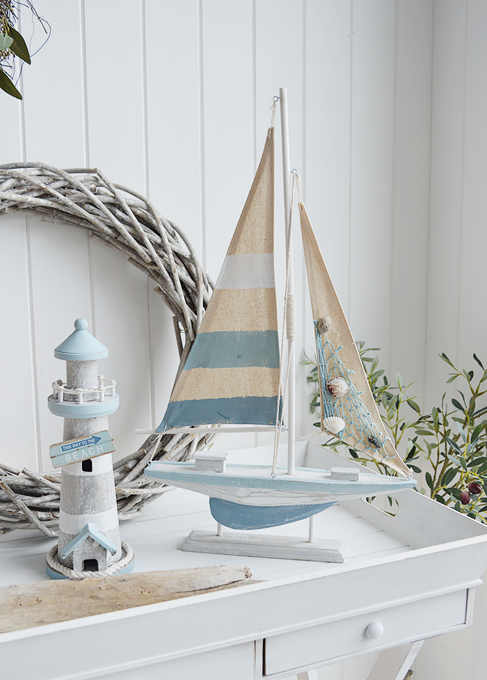 Blue and white wooden boat for coastal and nautical home decor and furniture