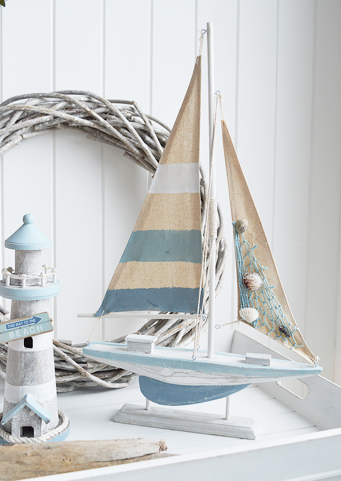 Blue and white wooden boat for coastal and nautical home decor and furniture