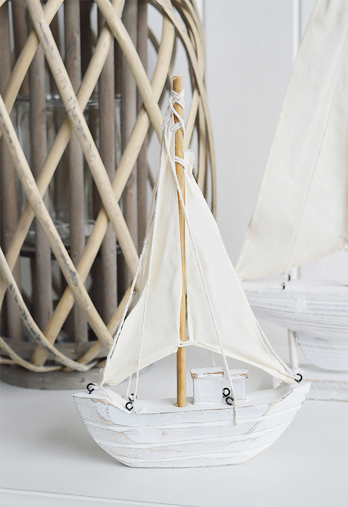 Nautical New England Coastal  Furniture and accessories for the home. A decorative white yacht from the White Lighthouse Furniture and Home interiors