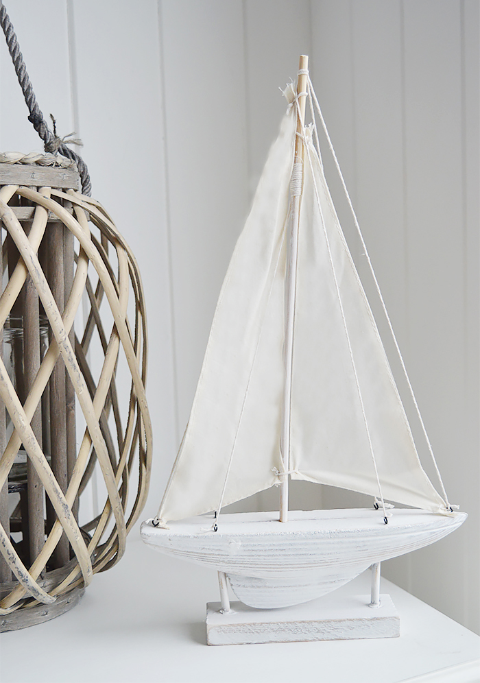 Nautical New England Coastal  Furniture and accessories for the home. A decorative white yacht from the White Lighthouse Furniture and Home interiors