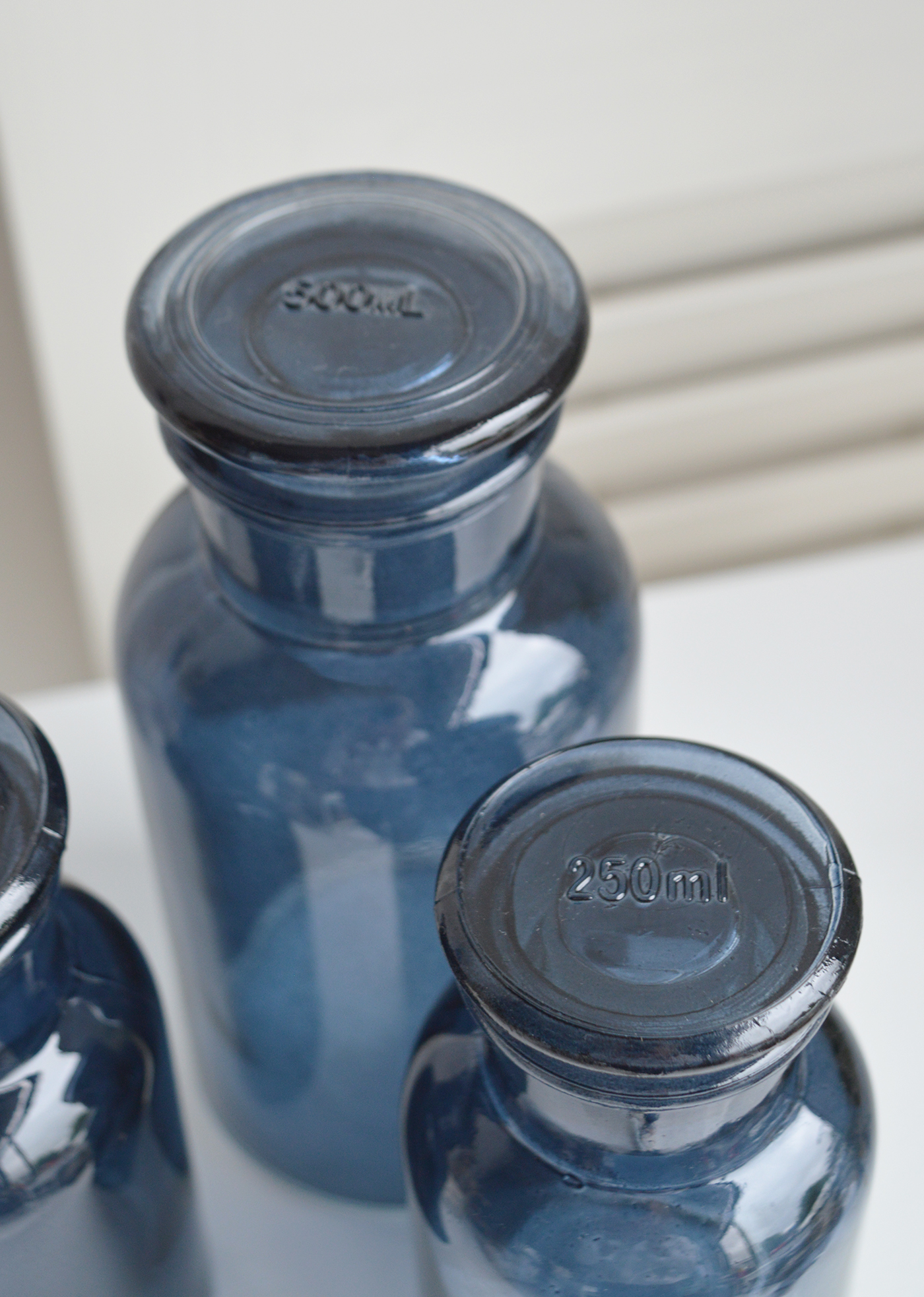 Decorative blue glass bottle with stopper from The White Lighthouse New England furniture and home accessories for country, coastal and city homes and iteriors