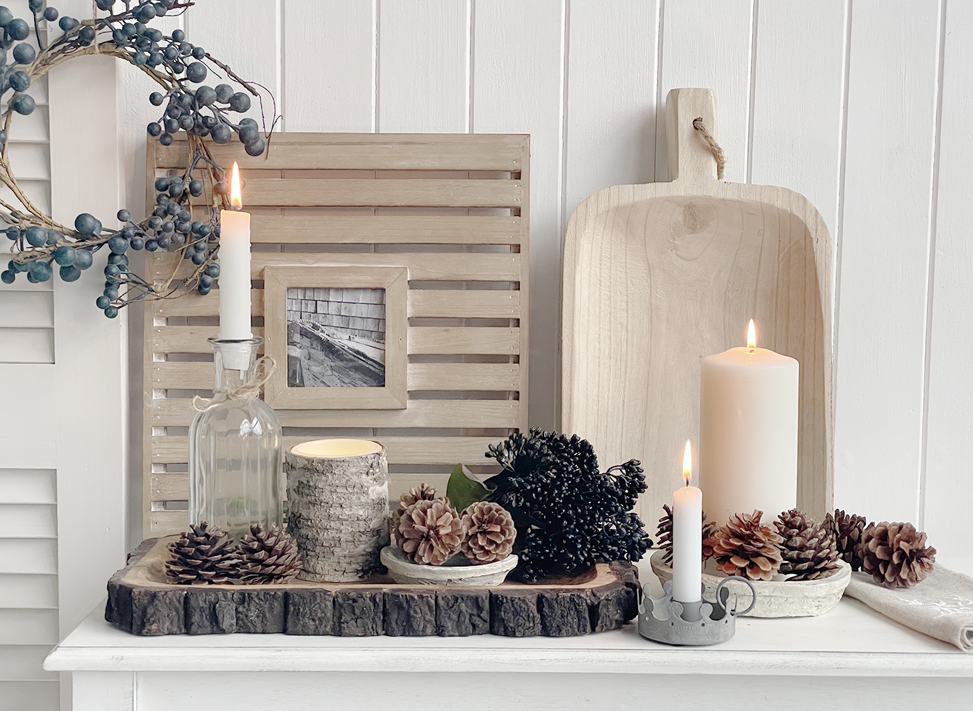 New England decor for winter time with berries and cones on wooden trays