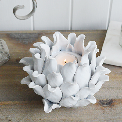 A white flower t light holder from The White Lighthouse furniture and accessories. New England interiors. Home decor and furniture for coastal, country and city homes