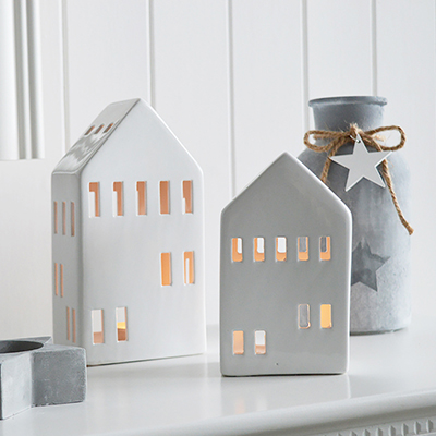 Delightful white ceramic house tealight holders

Available in 2 sizes, completely adorable even when the candle is no lit.

The candle holders are in the shape of town houses with multiple windows to the front, back, sides and roof, to let the light shine out.