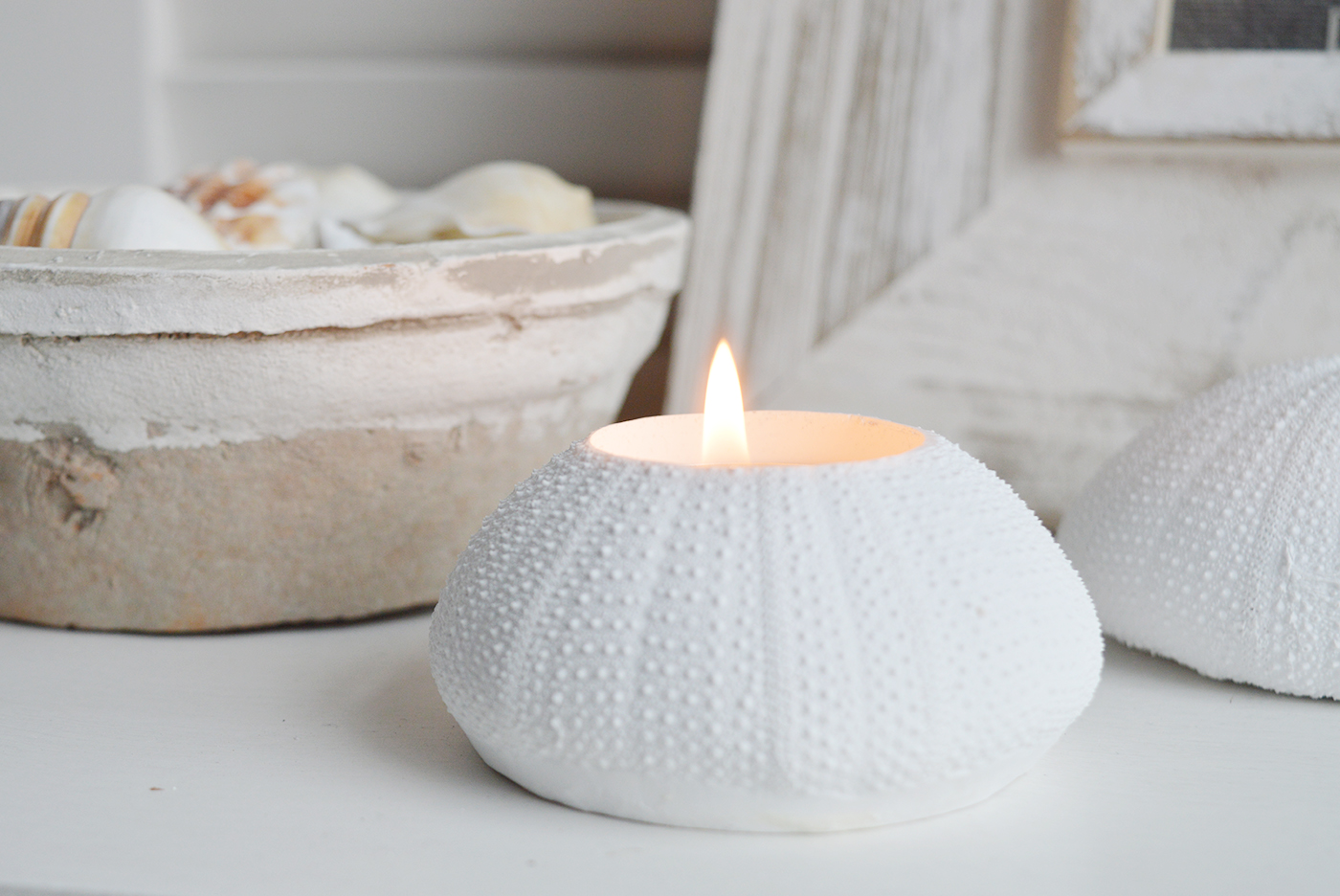 A white faux urchin candle holder for coastal styling in Hamptons and New England styled hoed and interiors