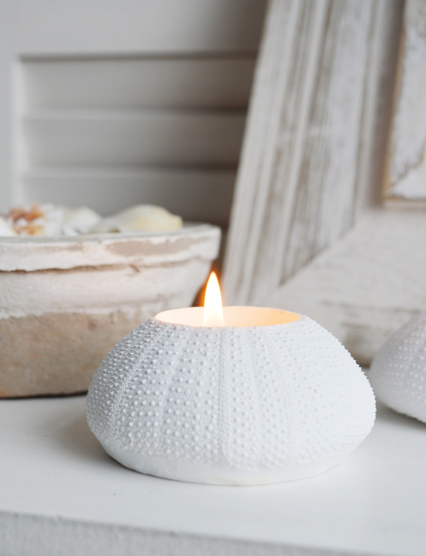 A white faux urchin candle holder for coastal styling in Hamptons and New England styled hoed and interiors