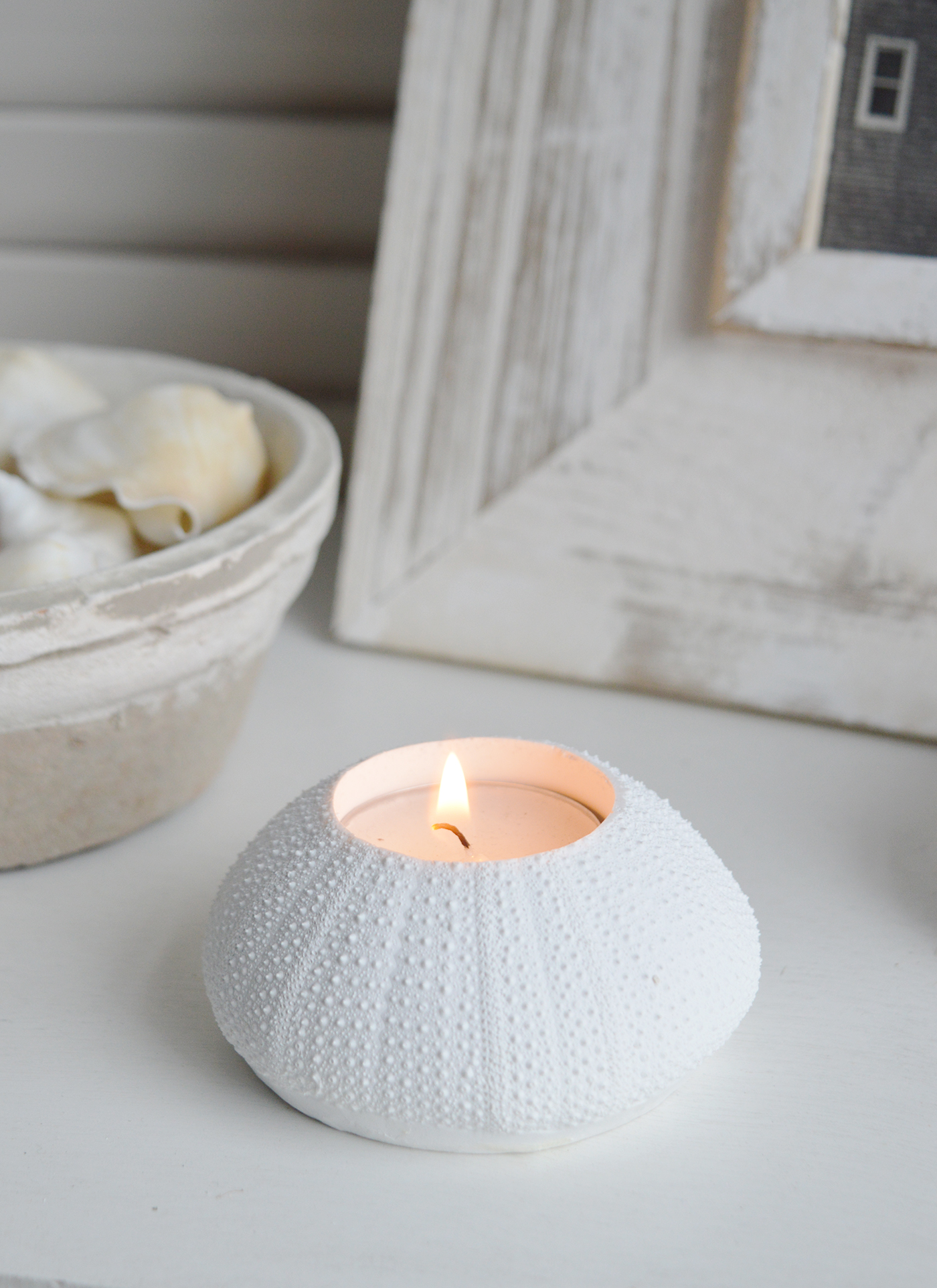 A white faux urchin candle holder for coastal styling in Hamptons and New England styled hoed and interiors